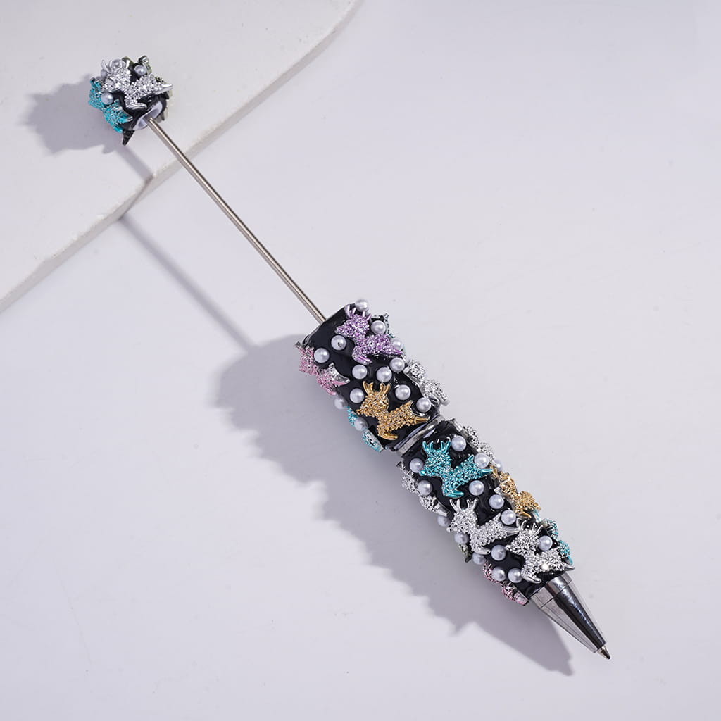 Decorative pen with colorful embellishments on a light gray background