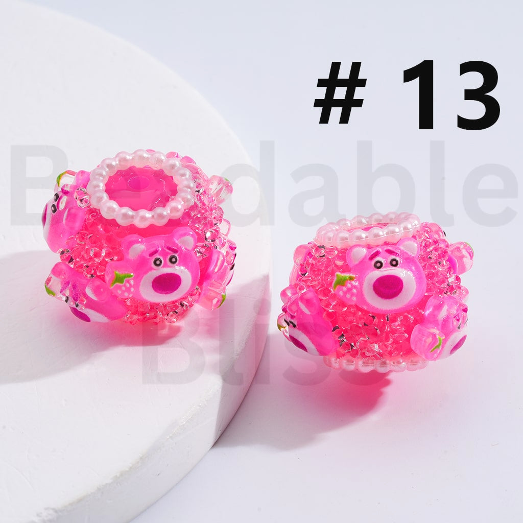 Two pink pig-shaped earrings with decorative elements on a white background.