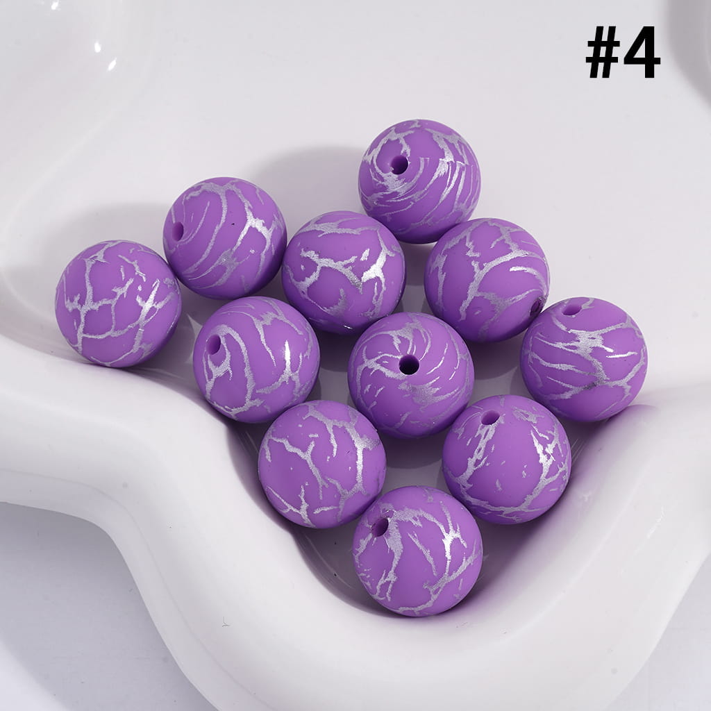 Purple marbled beads on a white dish