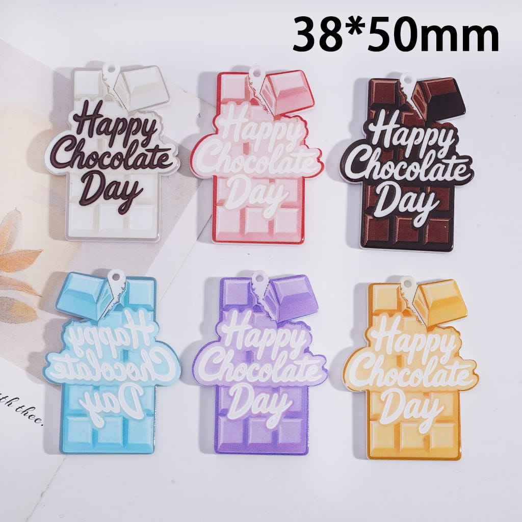 Colorful 'Happy Chocolate Day' charms on a white background