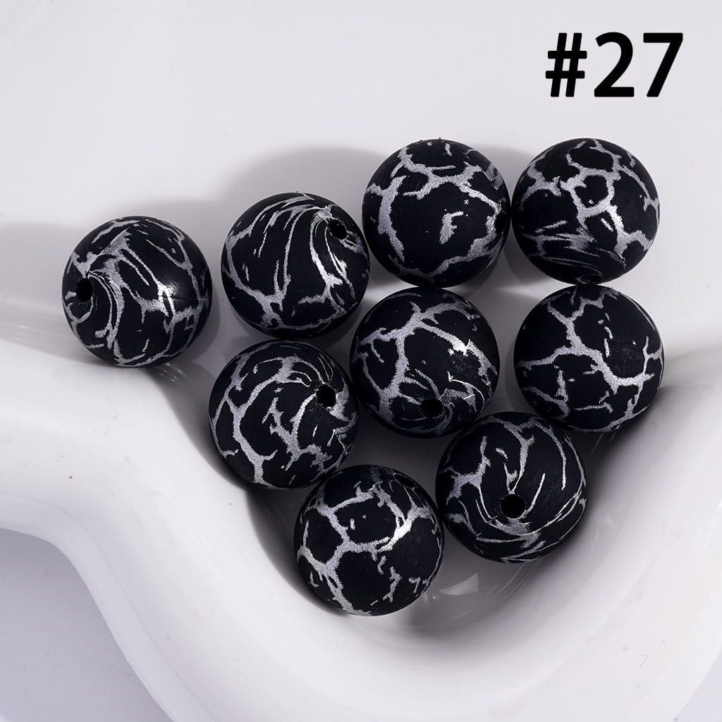 Black and white marbled beads on a white surface with the number 27 displayed.
