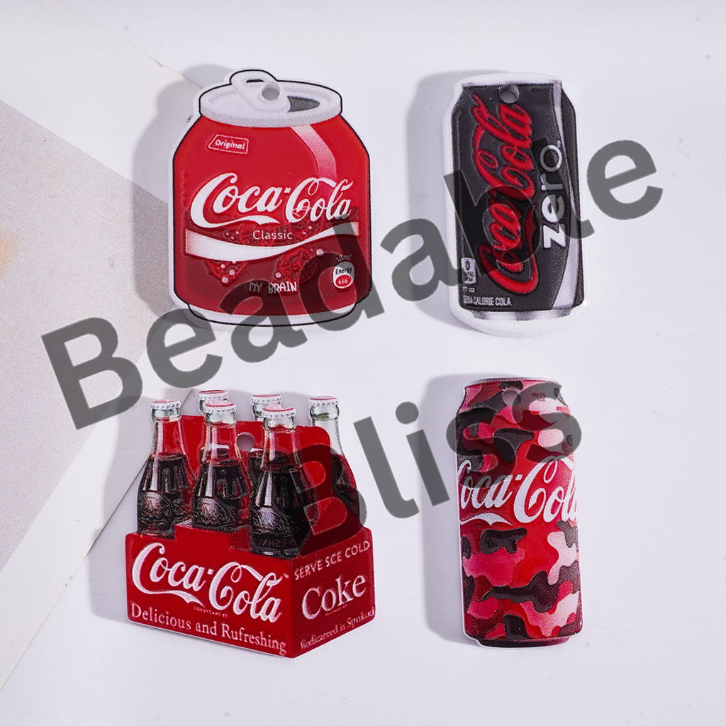 Collection of Coca-Cola products including cans and a box on a white background.