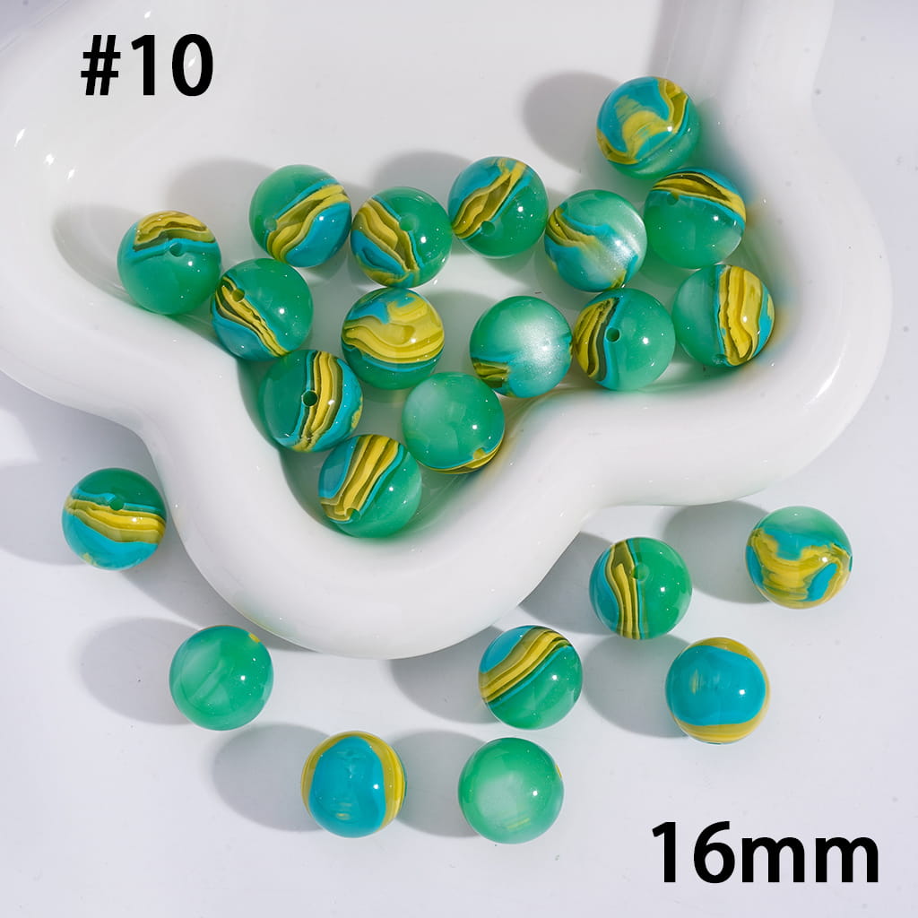 Green and yellow marbled beads on a white dish with '16mm' text.