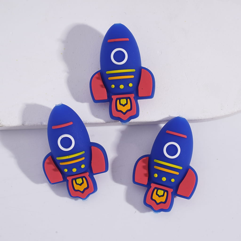 Three blue rocket-shaped earrings on a white background
