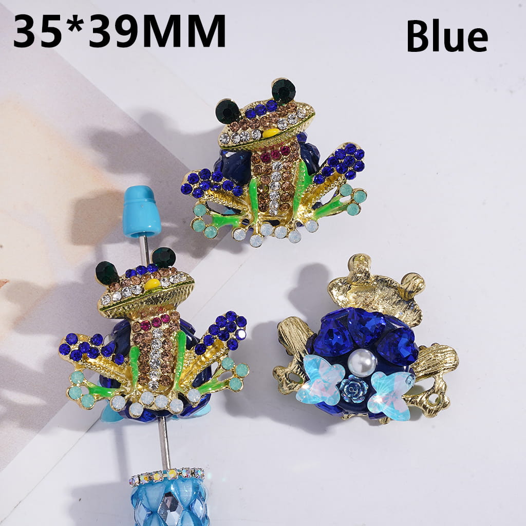 Decorative brooches with blue and gold details on a white background
