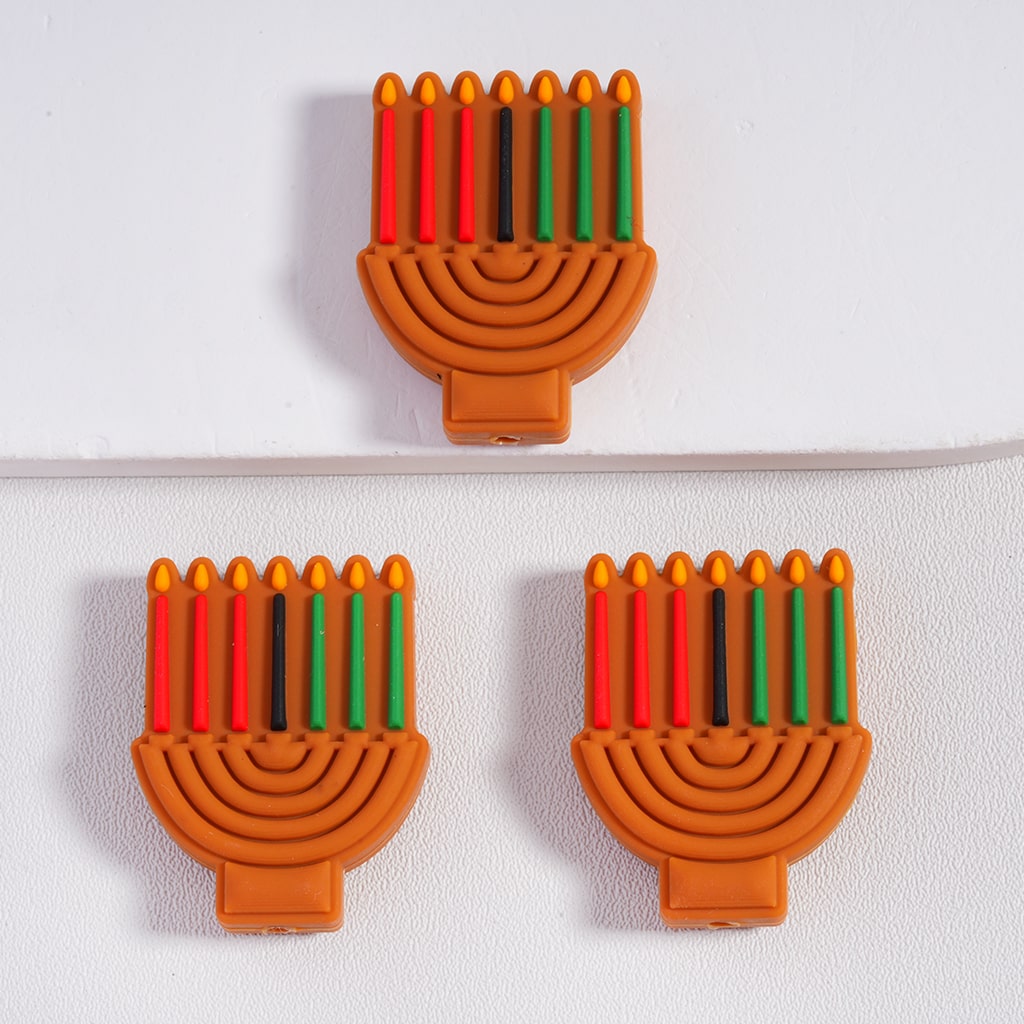 Three Hanukkah menorah-shaped cookies with candles on a white background