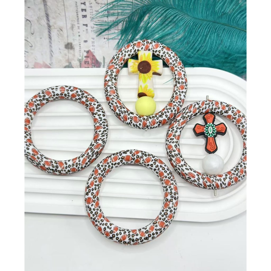 A set of round loop car hangers with jaguar prints and silicone ring frames displayed on a white surface.