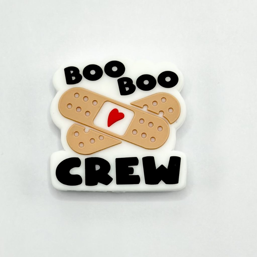 A silicone bead with the text 'BOO BOO CREW' and a heart symbol, designed to look like a band-aid plaster.
