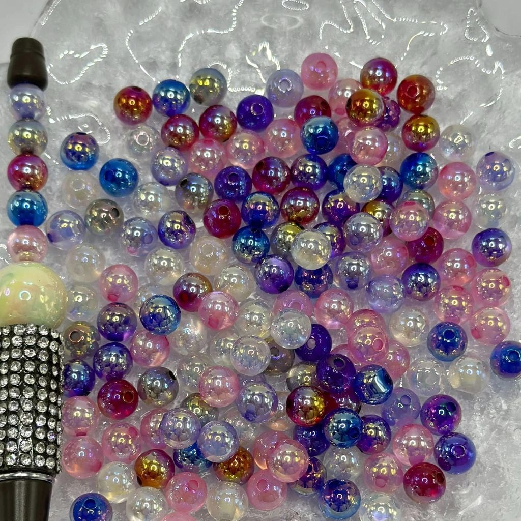 Colorful beads on a clear plastic background