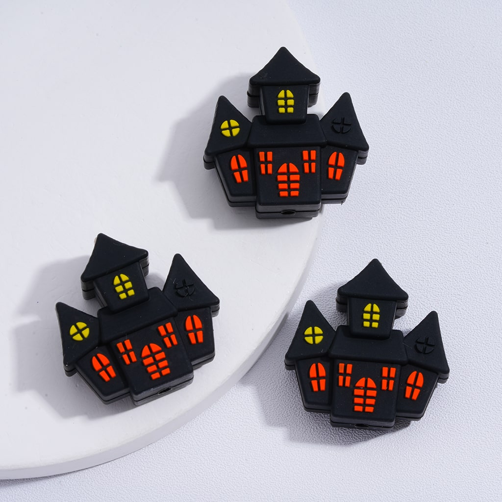 Halloween-themed black house-shaped lights on a white surface