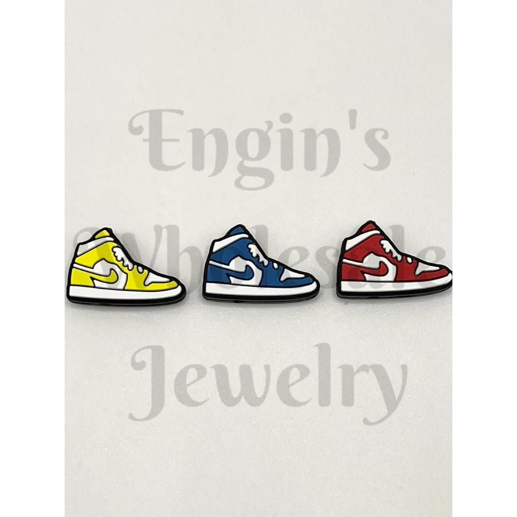 Three colorful shoe-shaped pins on a light gray background with 'beadbalebliss.com' branding.