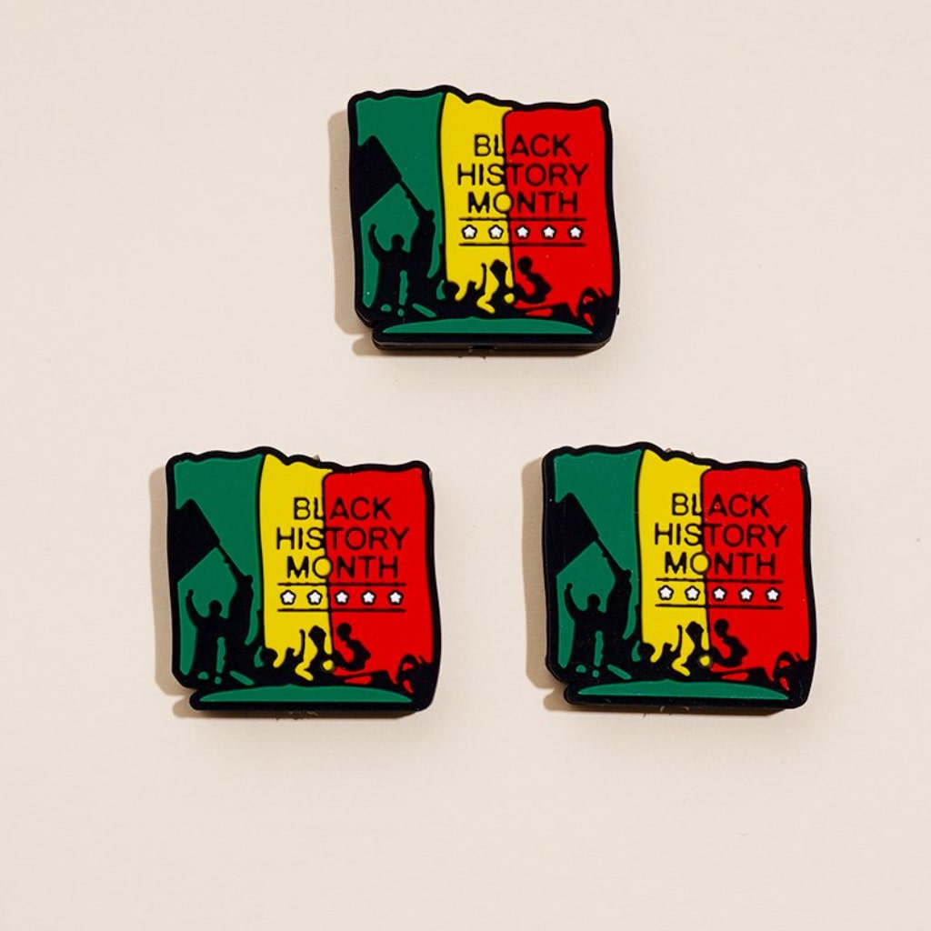 A set of three silicone beads with the Juneteenth Black History Month theme, featuring red and green colors and an illustration of a face.