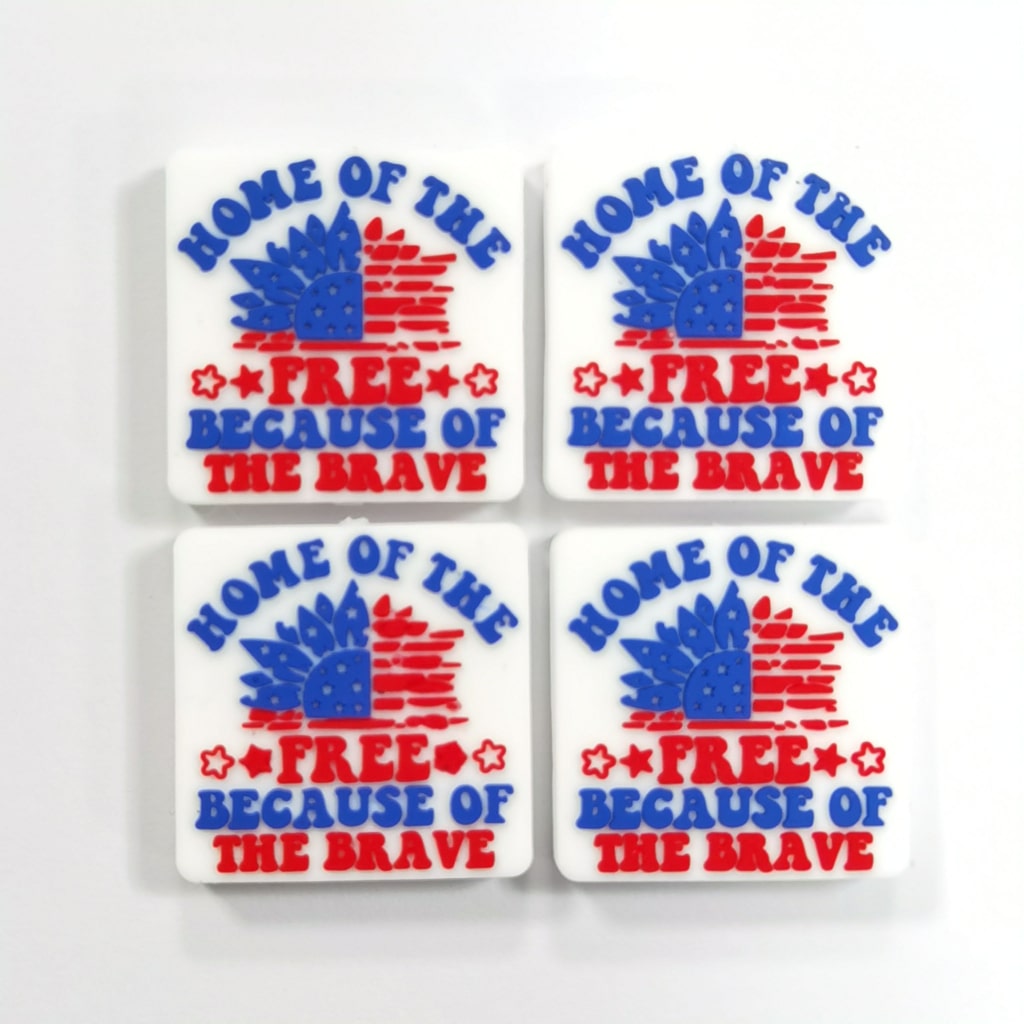Silicone beads with the text 'Home of the FREE Because of the BRAVE' printed on them, featuring a stars and stripes pattern.