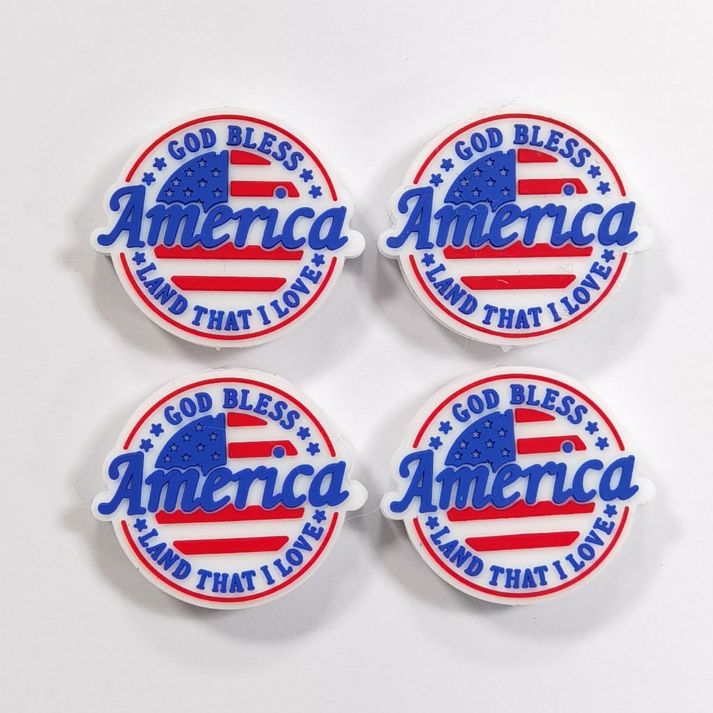 A set of silicone beads with the inscription 'God Bless America' and the American flag colors.