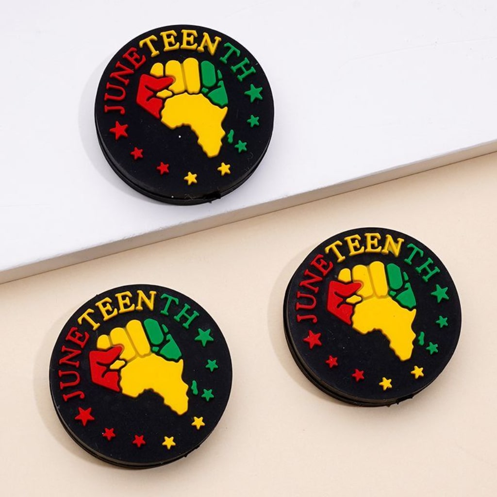 Round silicone beads in black with a colorful Africa map design and the text 'JUNETEENTH' featured prominently.