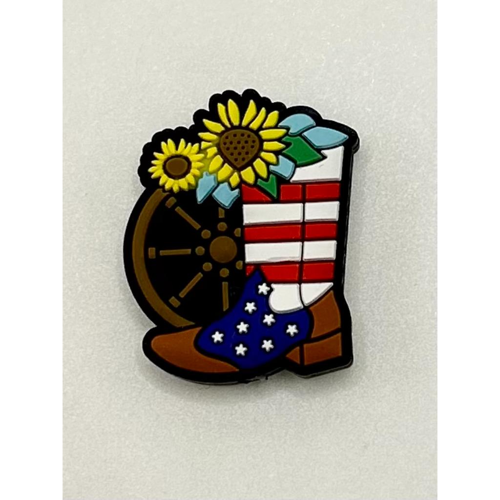 A silicone bead craft shaped like a steering wheel with a boot, featuring stars and stripes pattern, likely representing an American flag motif, with sunflower designs on the top.