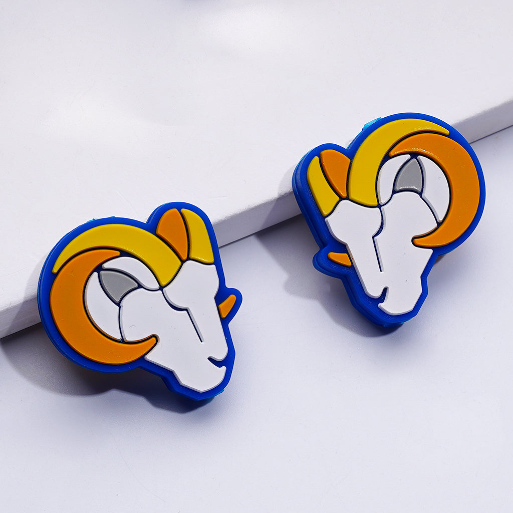 Pair of ram-shaped earrings with blue, orange, and white colors on a white background.