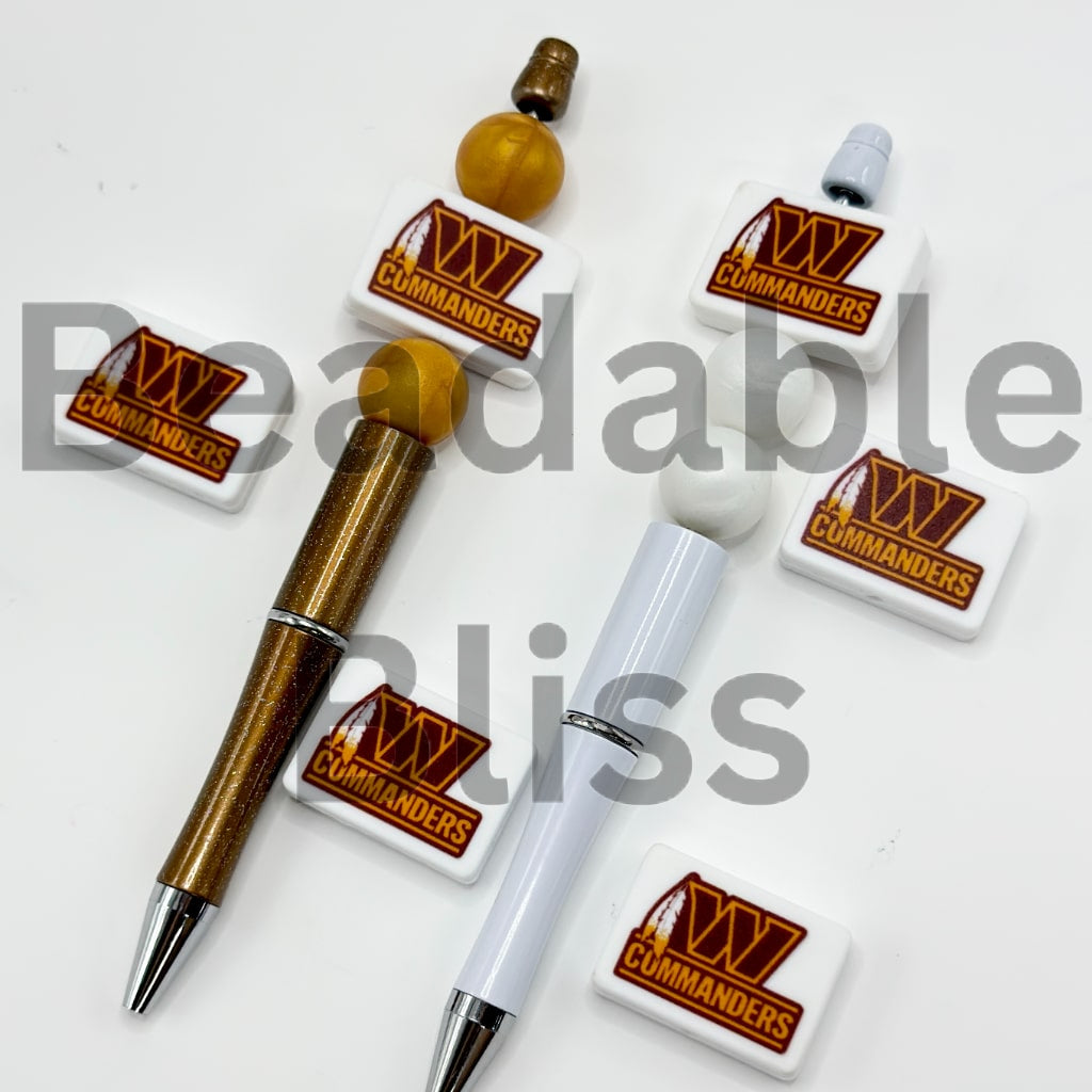 Two pens with 'XV Commanders' branding on a white background