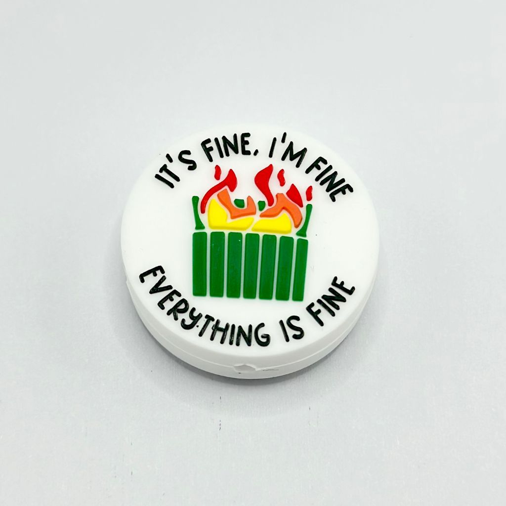 A round silicone bead with the text 'IT'S FINE, I'M FINE, EVERYTHING IS FINE' and an illustration of a flame on it.