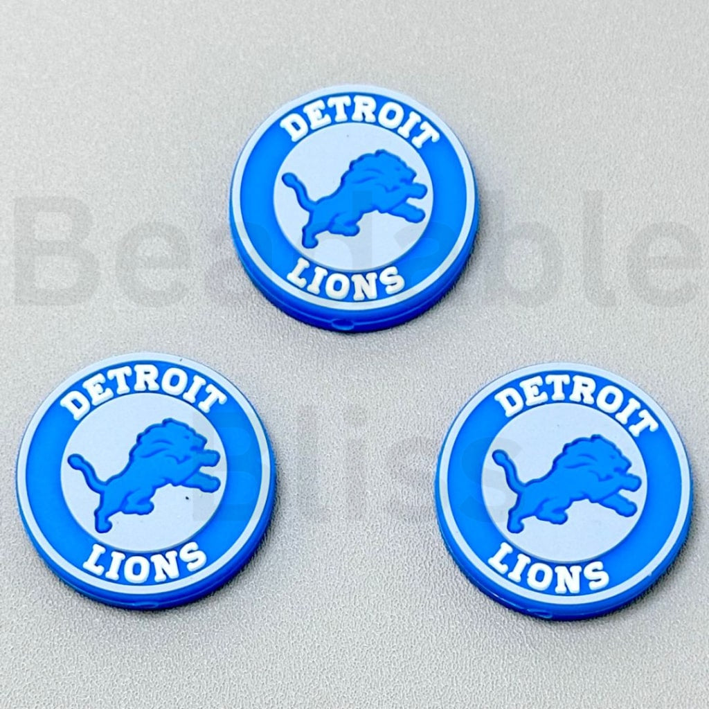 Three Detroit Lions logo coasters on a gray background