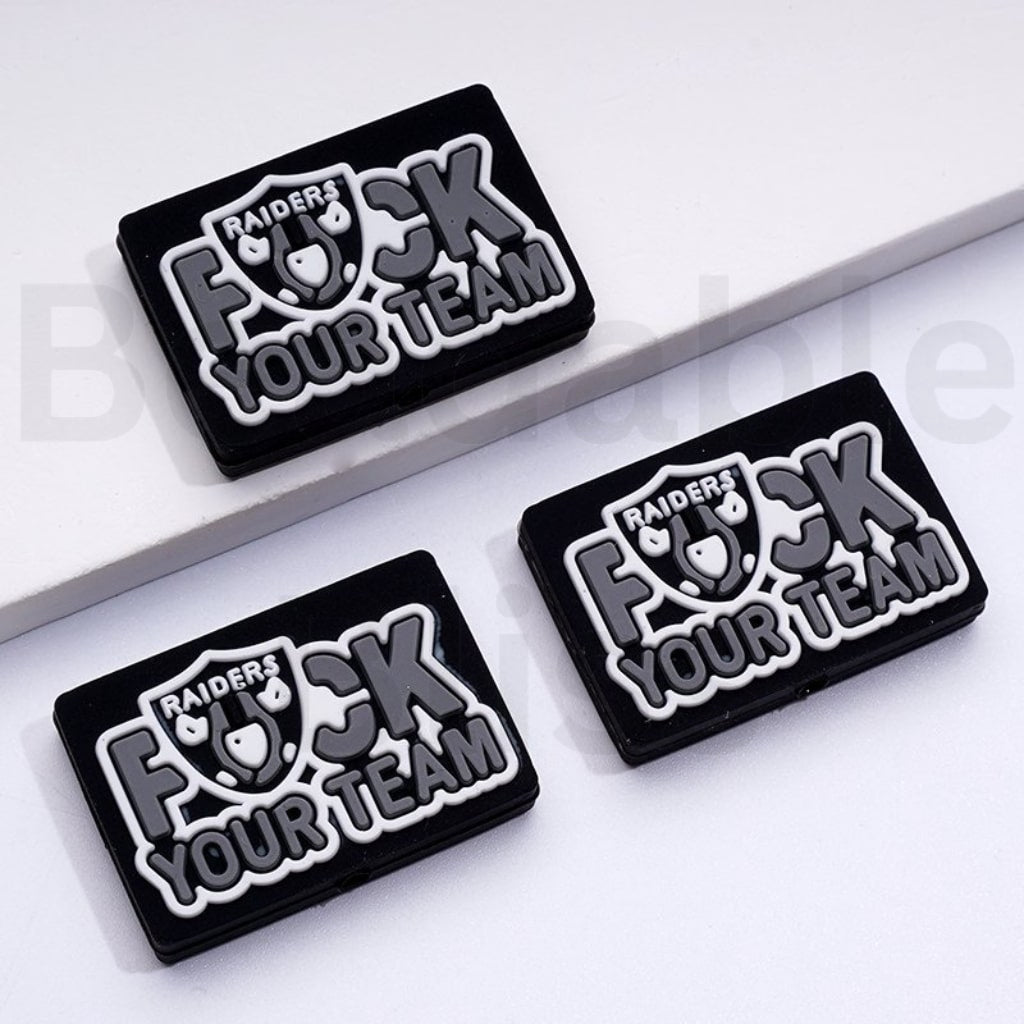Three 'RAIDERS F*CK YOUR TEAM' patches on a white background
