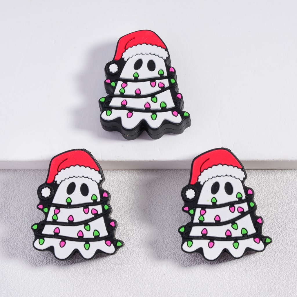 Three Christmas-themed ghost pins with Santa hats on a white background