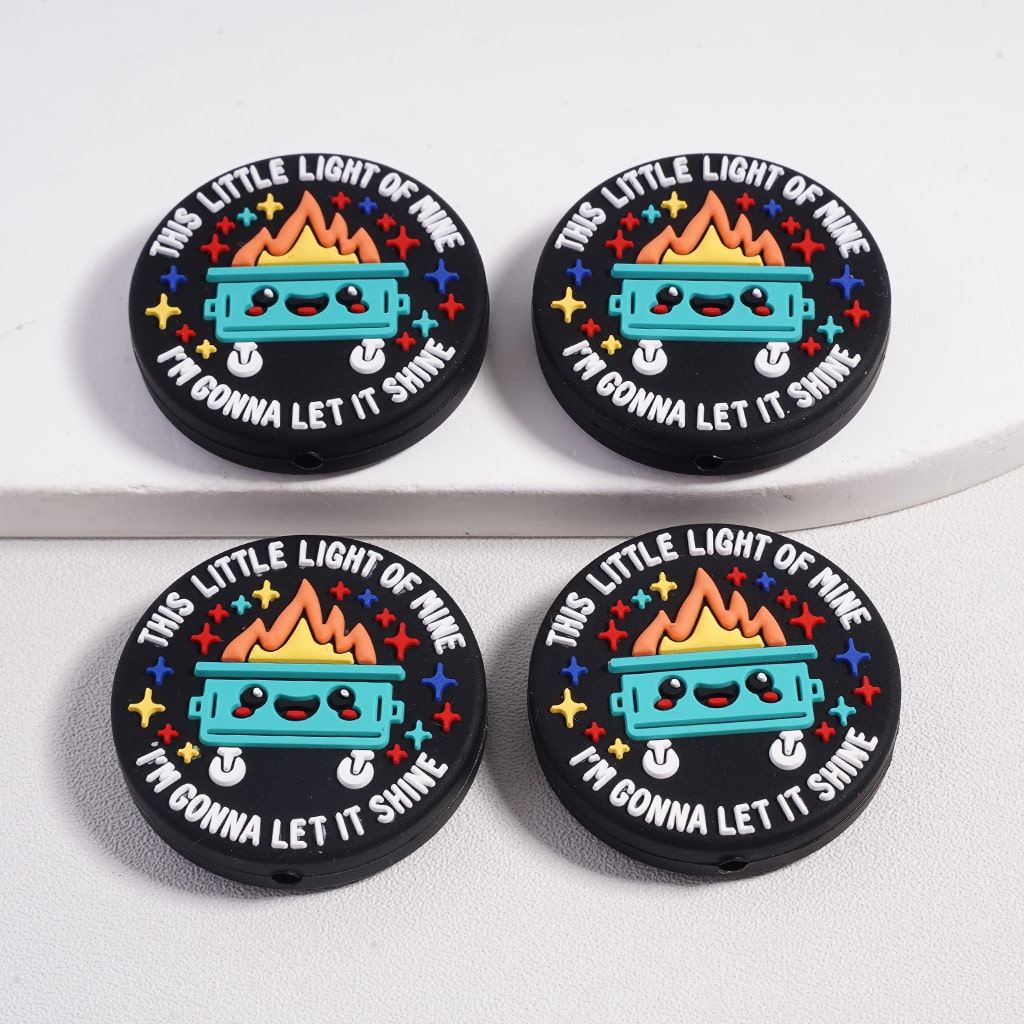 Four round stickers with a colorful design and text on a white background