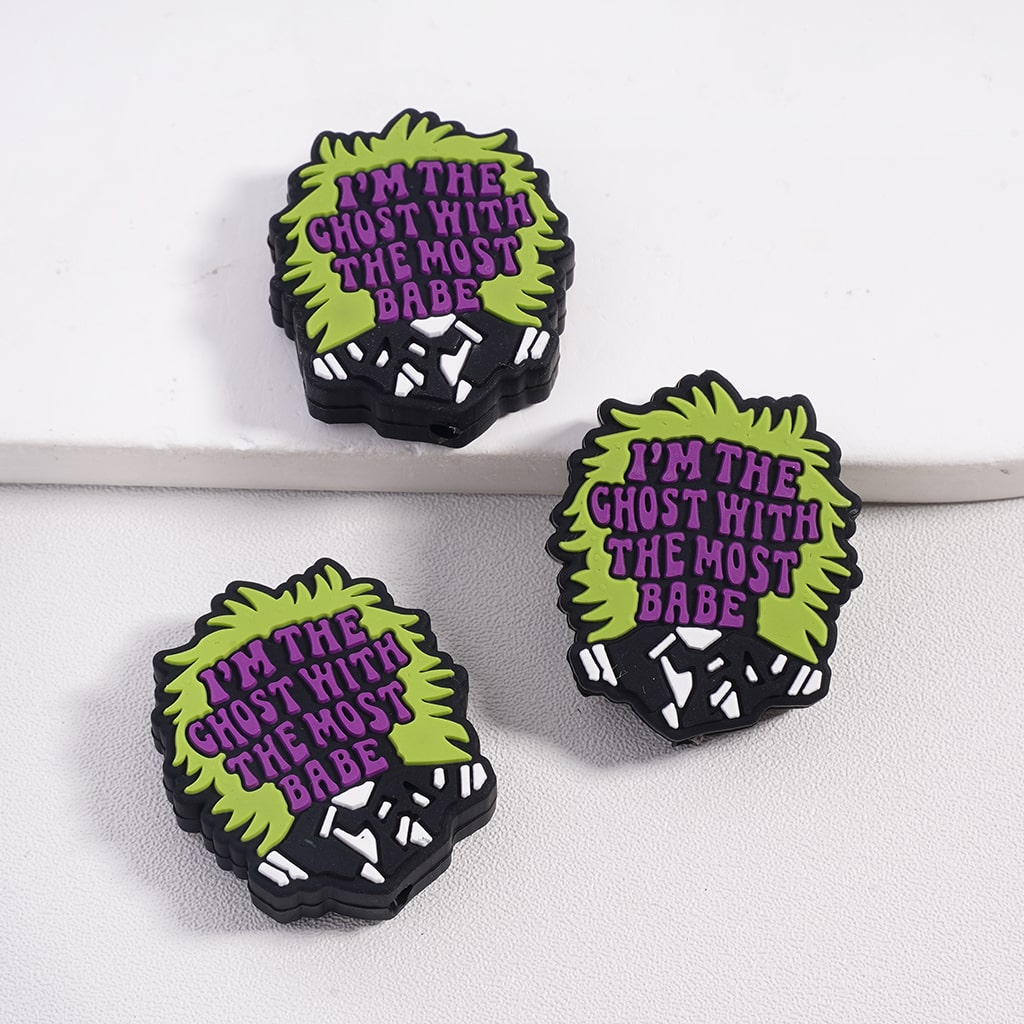 Three ghost-shaped pins with text on a white background