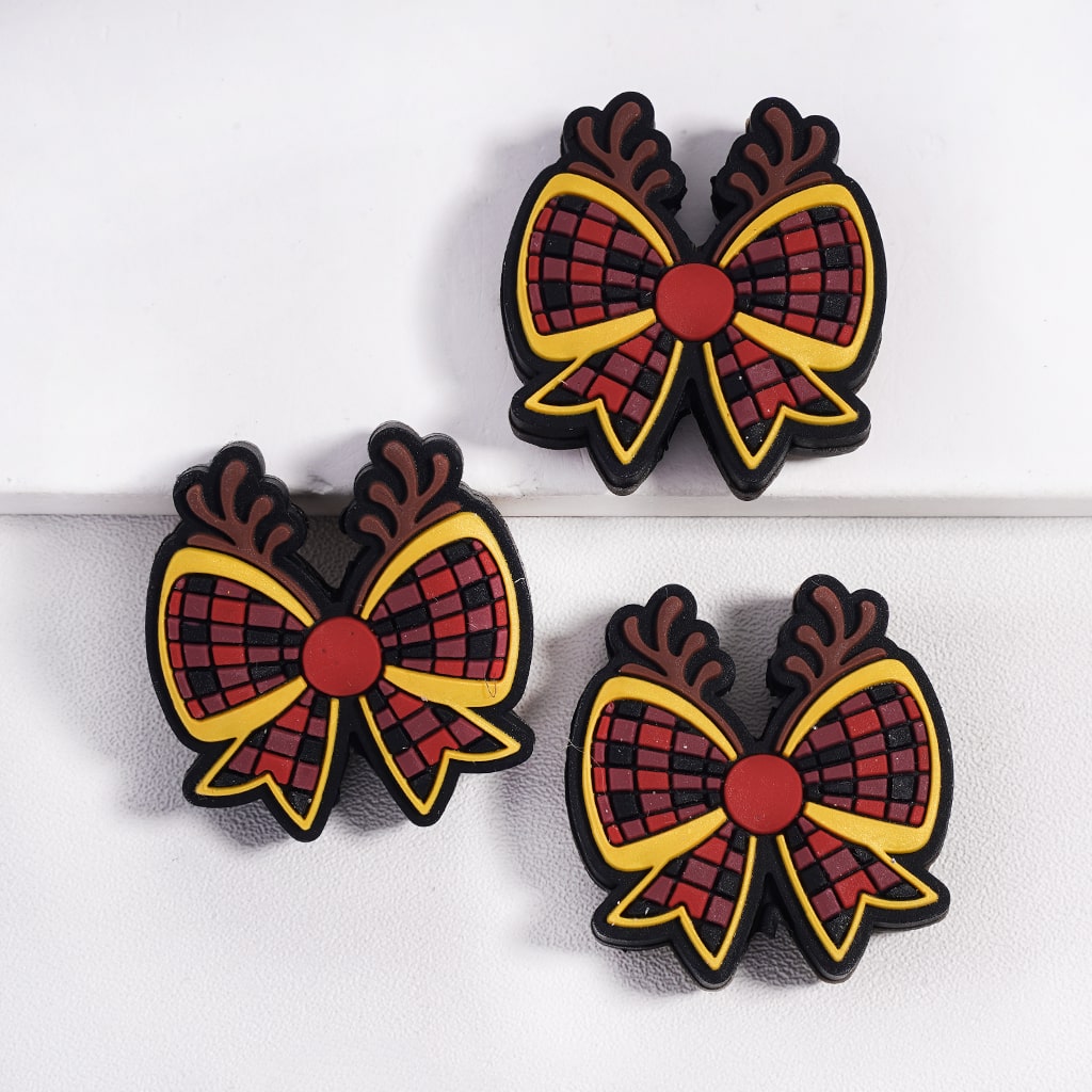 Three plaid bow-shaped earrings on a white background
