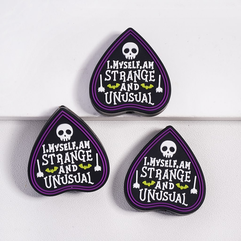 Three purple and black patches with text and skull designs on a white background