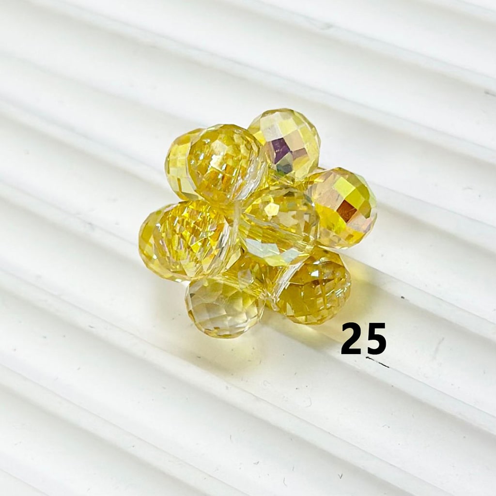 Yellow glass beads on a white background with number 25