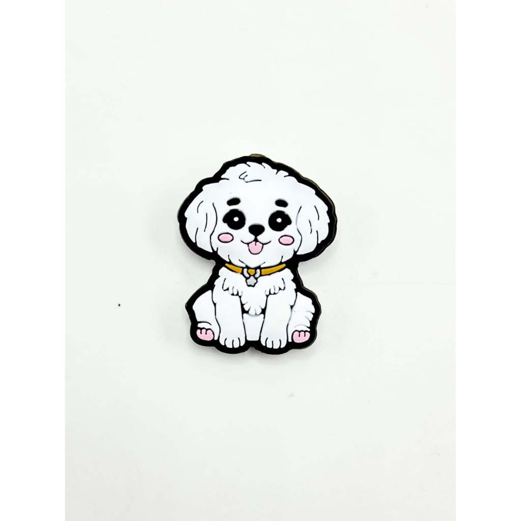 A silicone bead in the shape of a cartoon-style white dog with a black outline and details.