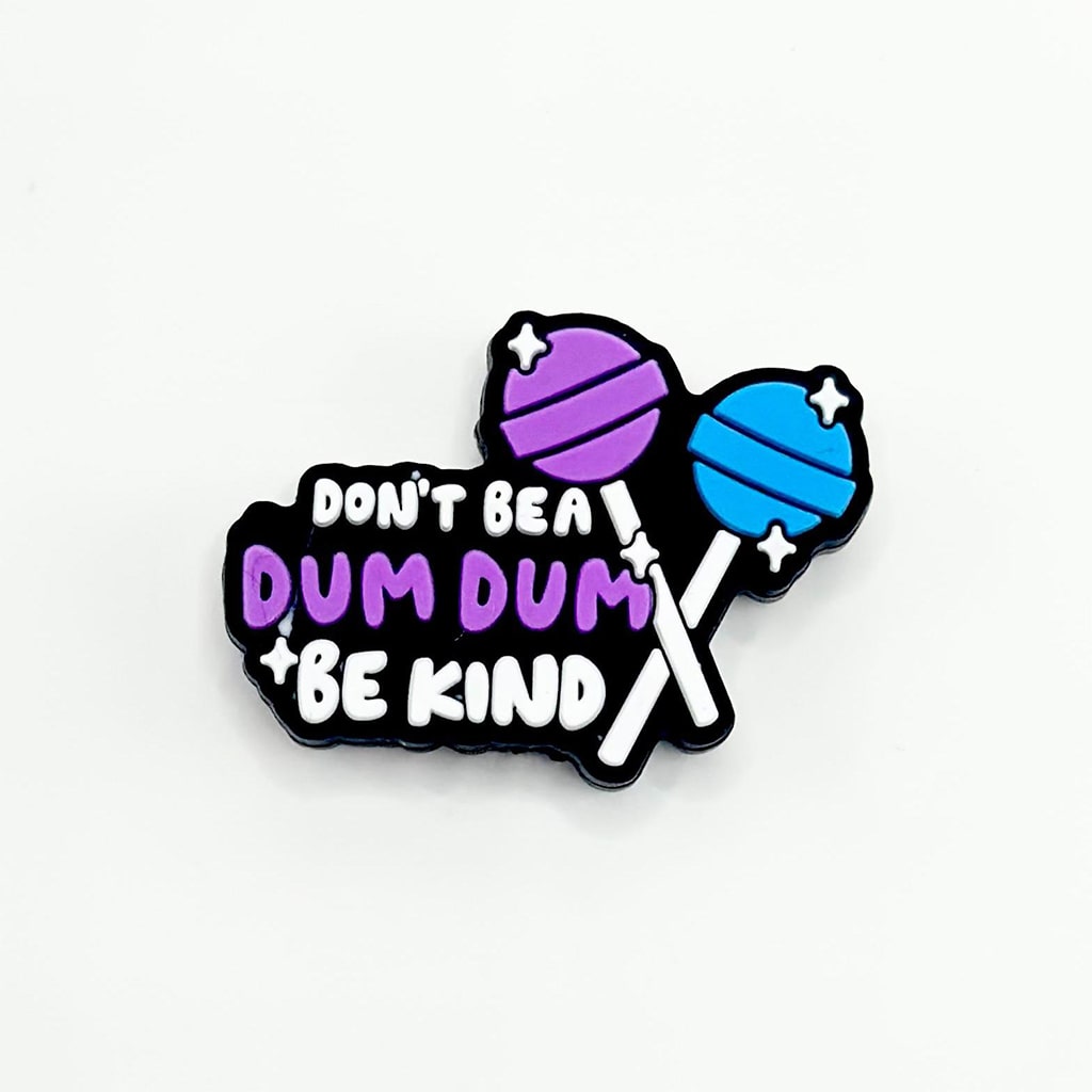 A set of silicone beads in the shape of lollipops with the text 'DON'T BE A DUM DUM BE KIND' written on them in black, purple, and blue colors.