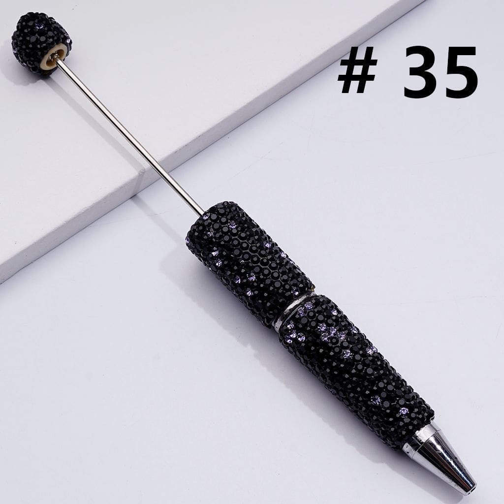 Black embellished pen on a light gray background with the number 35.