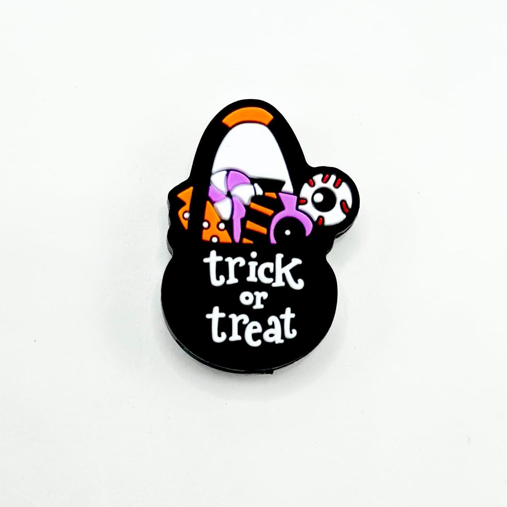 A silicone focal bead designed for beadable pens with a Halloween 'Trick or Treat' motif, featuring black, orange, and purple colors.