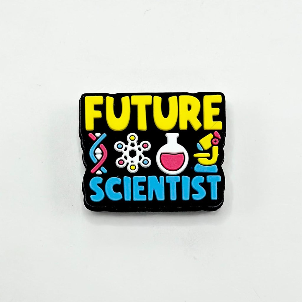 A silicone bead with 'FUTURE SCIENTIST' written on it, featuring multicolored scientific icons such as a magnifying glass, a test tube, and a brain.