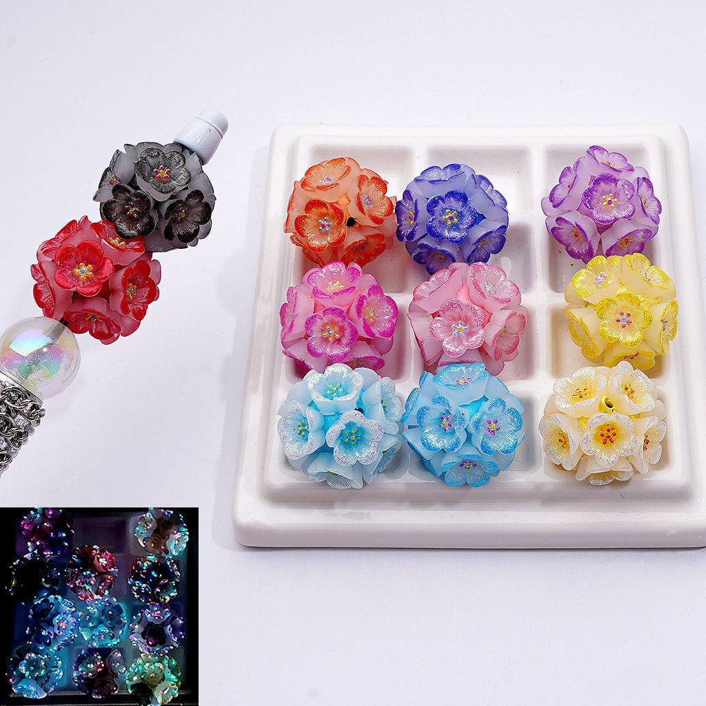 Colorful flower-shaped candles on a white tray with close-up inset showing glowing effect.
