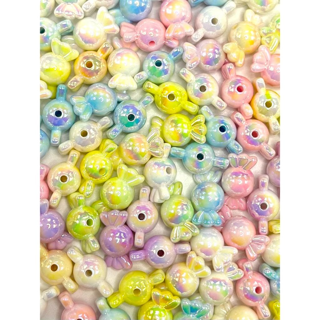 Assorted pastel-colored beads with various shapes on a white background