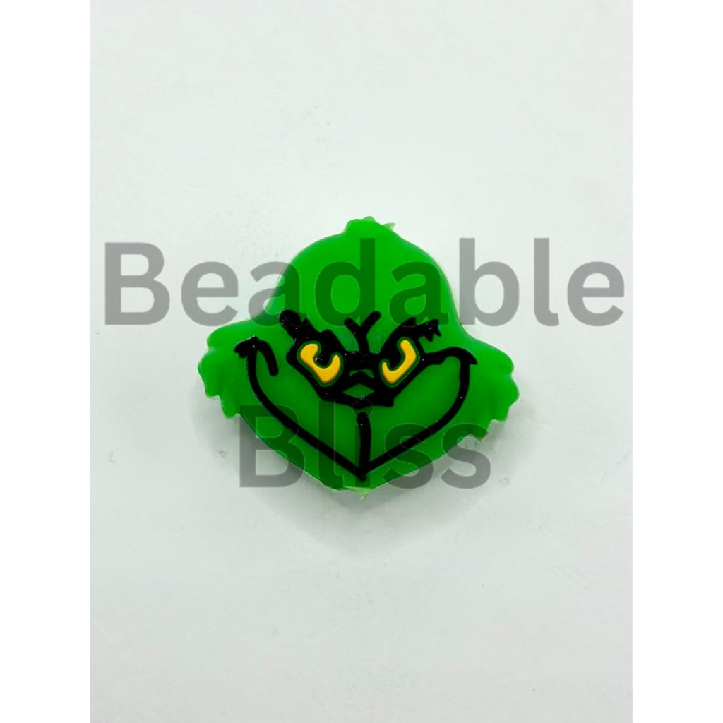 Green character head with a grumpy expression on a white background