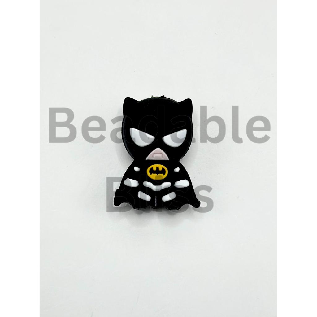 Black cat-shaped object with a yellow logo on a white background