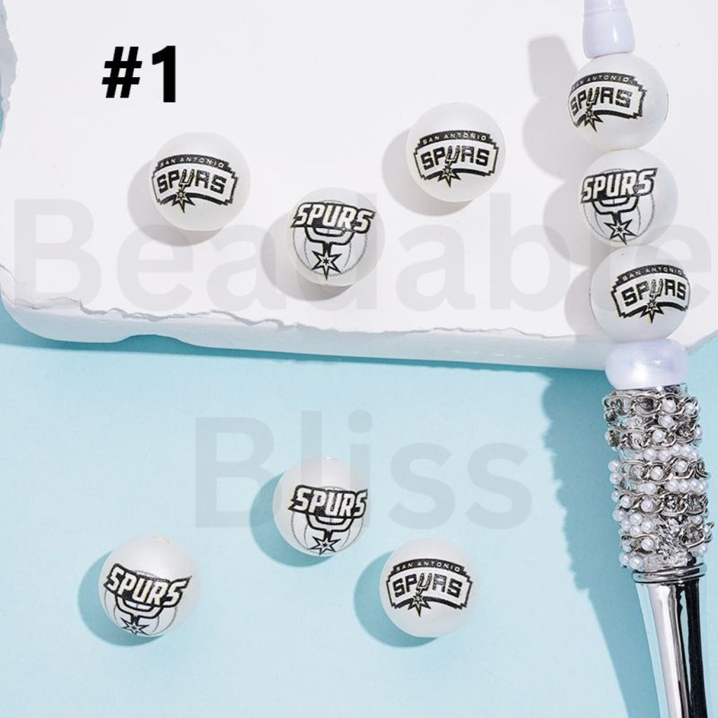Spurs-themed hair tie with multiple loops on a light blue background