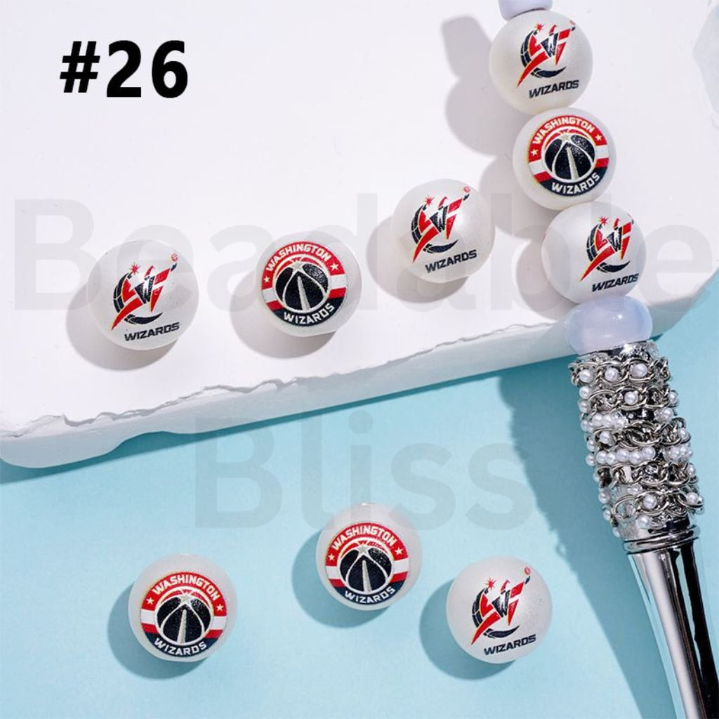 Washington Wizards logo on white balls with a decorative pen on a light blue background