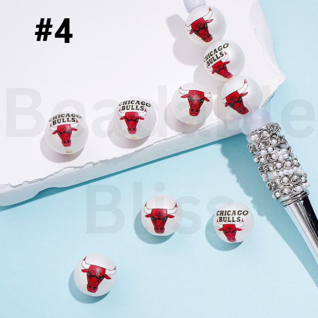 Chicago Bulls-themed earrings on a light blue background with a decorative object.