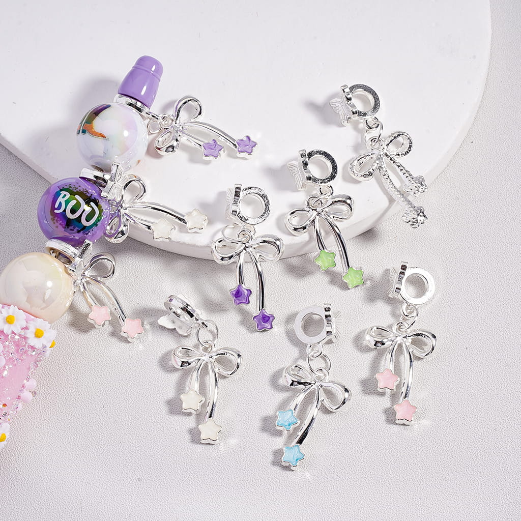 Silver charm bracelet with various charms on a white background