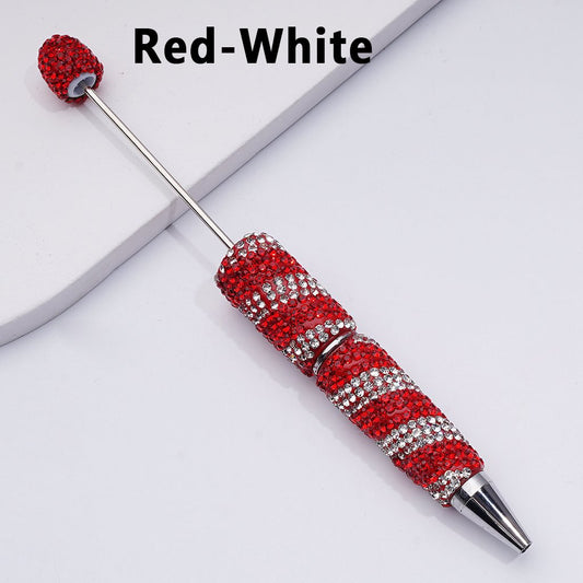 Decorative pen with red and white accents on a light gray background

