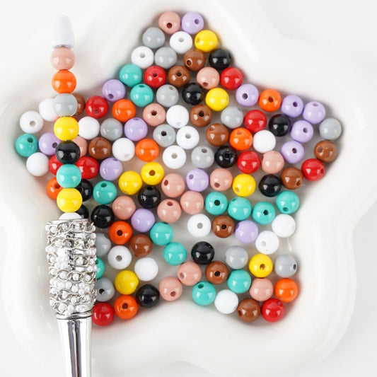 Colorful beaded hairbrush on a white background