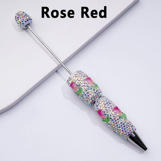 A set of beadable clay pens with mini cute tulip flowers, fully covered in AB rhinestones, displayed on a white surface.

