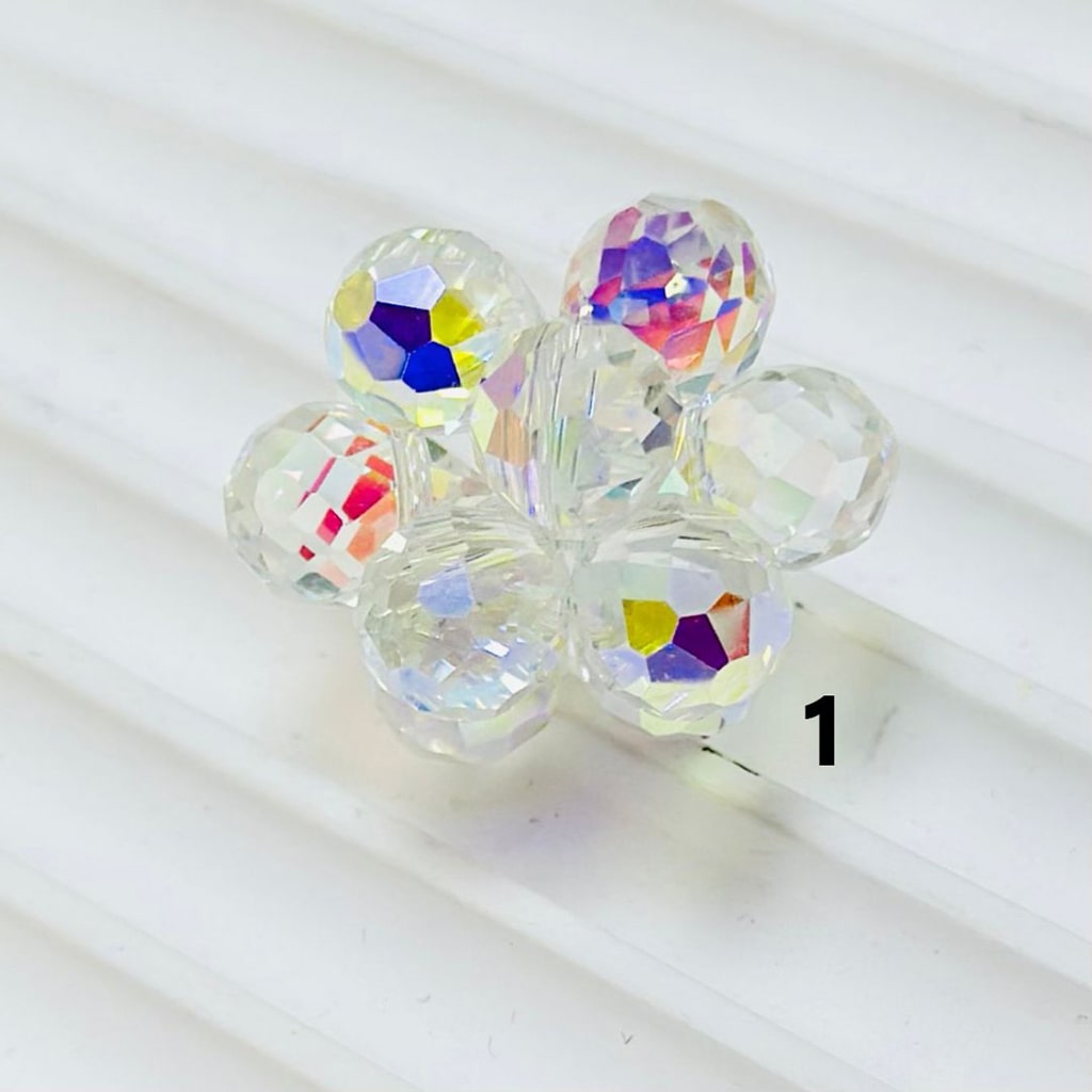 Clear beads with colorful faceted patterns on a white background


