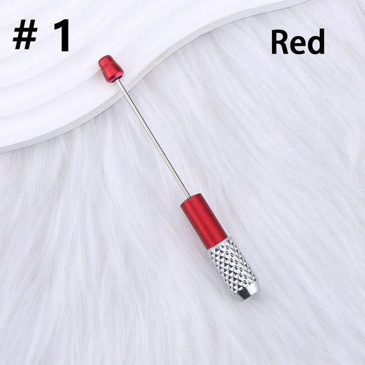 Red and silver cocktail stirrer on a white background

