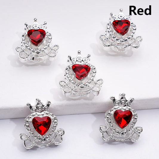 Five silver heart-shaped jewelry pieces with red gemstones on a white background.

